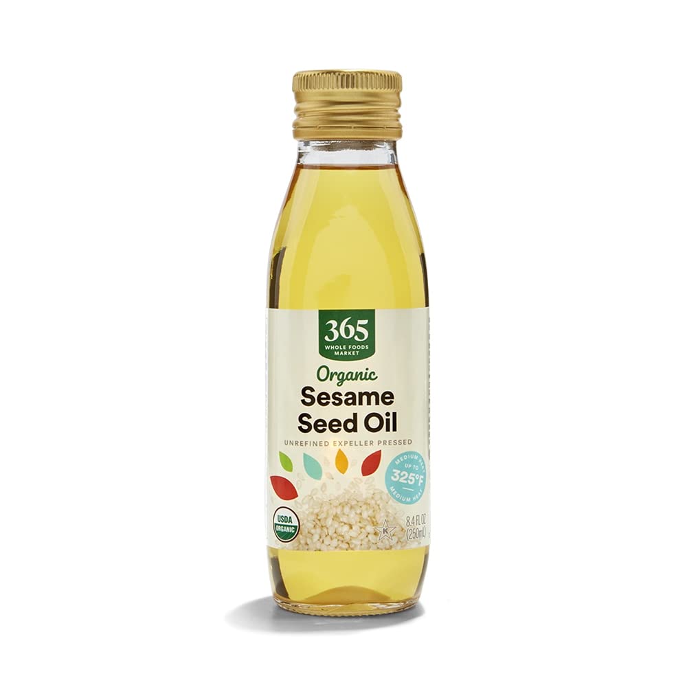 365 by Whole Foods Market Organic Sesame Seed Oil pouring over a hot stir-fry