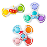 ALASOU pop suction spinner on fridge for focused play and motor skills.