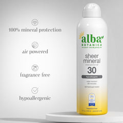 Woman applying Alba Botanica sunscreen spray for quick, light coverage.