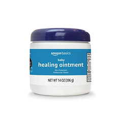 Amazon Basics Healing Ointment applied to baby's cheek for dry skin relief.