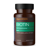 Amazon Elements Biotin 5000 mcg bottle close-up highlighting hair and nails support.
