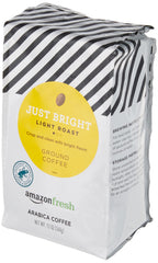 Amazon Fresh Just Bright ground coffee grounds close-up for rich morning drip.