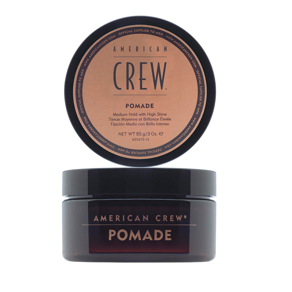 American Crew pomade bottle for medium hold and high shine, ideal for sleek or textured looks.