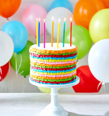 American Greetings birthday candles on a cake create a festive focal point