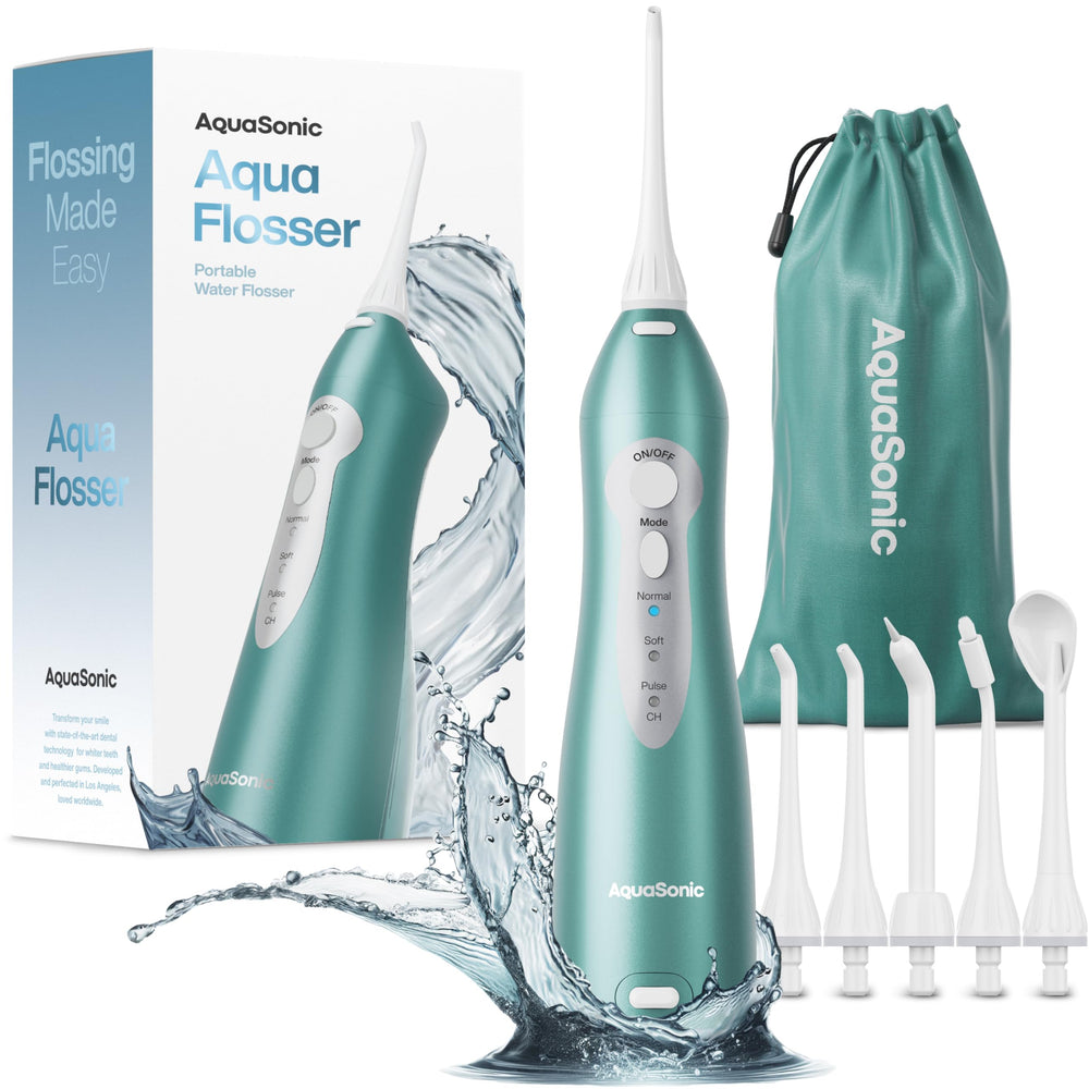 Aquasonic water flosser on table shows compact cordless design for travel and daily use.