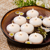 Ashlux white 2-inch floating candle in a 24-pack centerpiece decor.