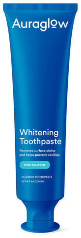 Auraglow whitening toothpaste tube close-up highlighting enamel protection and whitening action.