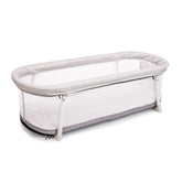 Baby Delight Snuggle Nest Bassinet in Driftwood Grey with fold-out legs for portability.