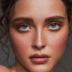 Freckles placed along nose and cheeks for sun-kissed realism.