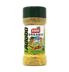 Badia Organic Adobo Seasoning bottle on kitchen counter adds versatile flavor to meats and veggies.