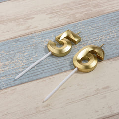 Close-up of Bailym glitter gold candles for elegant cake decoration