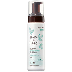 Bain de Terre Rise N' Shine bottle pouring for instant root lift.