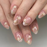 Bloazife nude pink flower press-on nails in almond shape for a quick, salon-like manicure.
