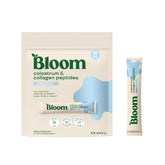 Bloom Nutrition bovine colostrum powder packet on table ready to mix for immune support