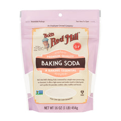 Pouring Bob's Red Mill baking soda into batter for rise.