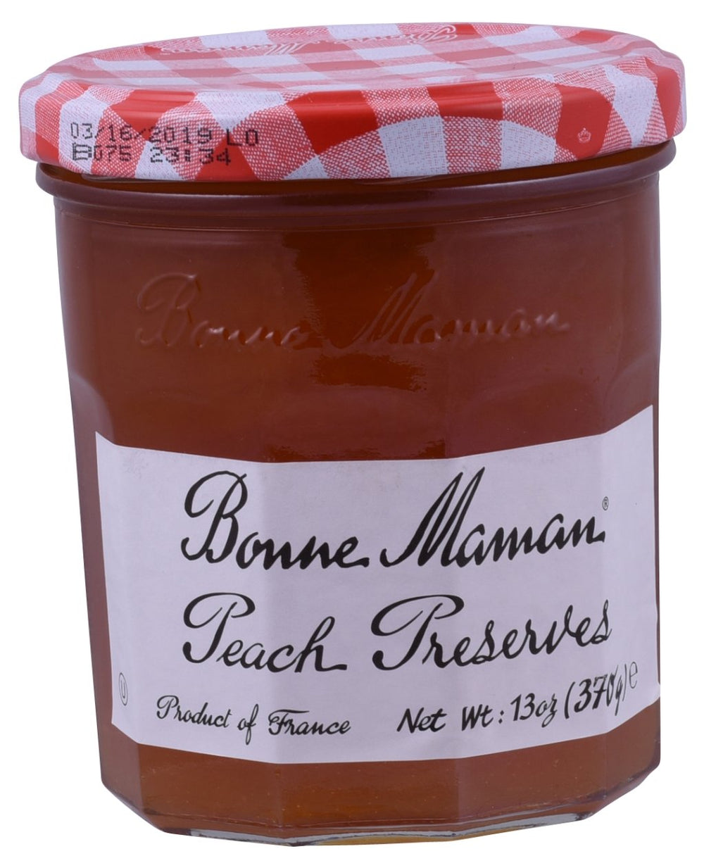 Bonne Maman Peach Preserve jar on a rustic surface, vivid peach flavor, ideal for toast.