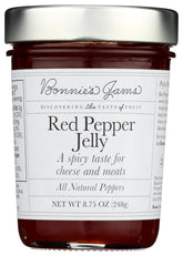 Bonnie's Jams Red Pepper Jelly jar on a cheese board for pairing.