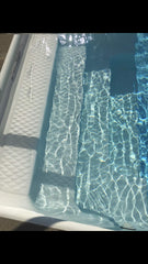 Rust and metal stains fading after using Vanish in pool.
