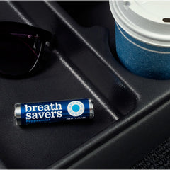 Breath Savers peppermint roll in car cup holder for on-the-go freshness.