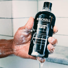 Brickell Men's Relieving Dandruff Shampoo label closeup, natural ingredients highlighted.