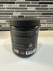 Bucked Up Pre Workout grape scoop beside the tub ready to measure.