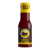 Buffalo Wild Wings Sweet and Sour Sauce bottle pouring onto grilled chicken for a tangy glaze.