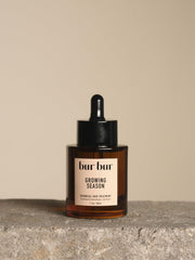 Bur Bur Growing Season oil bottle front view shows a nourishing scalp care option