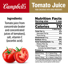 Campbell's tomato juice poured over ice with lime, a crisp on-the-spot sip.