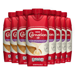 Carnation lactose-free evaporated milk bottle pouring to show creamy texture for cooking