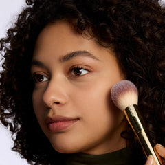 Face after application showing a soft matte finish with a subtle pink tint.