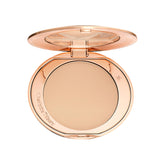Charlotte Tilbury Airbrush Flawless Finish Powder compact blurs pores for a soft-focus finish.