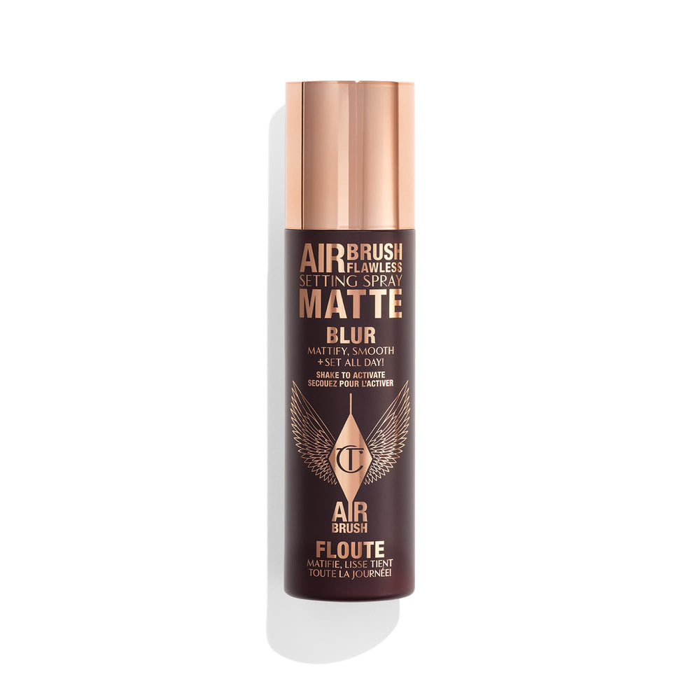 Charlotte Tilbury Airbrush Flawless Setting Spray bottle releasing an ultra-fine mist for priming makeup.