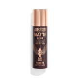 Charlotte Tilbury Airbrush Flawless Setting Spray bottle releasing an ultra-fine mist for priming makeup.