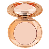 Charlotte Tilbury Magic Vanish under-eye application demonstrates peach-toned correction for brighter eyes
