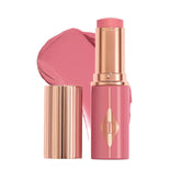 Charlotte Tilbury Unreal Healthy Glow Blush Stick close-up applying for a luminous rosy glow.