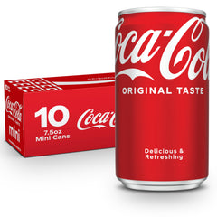Coca-Cola fridge-pack cans on a kitchen counter, ready to chill with meals.