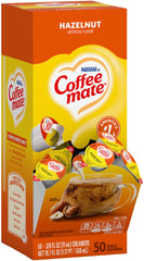 Coffee Mate Hazelnut Singles poured into coffee for quick creaminess.