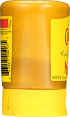 Close-up of Colman's mustard texture, smooth and ready to spread.