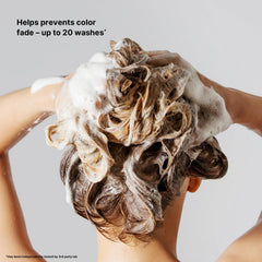 Rinsing action reveals a residue-free finish after using Color Wow Shampoo.