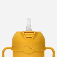 Comotomo Toddler Tumbler yellow spout offers easy sip option for meals.