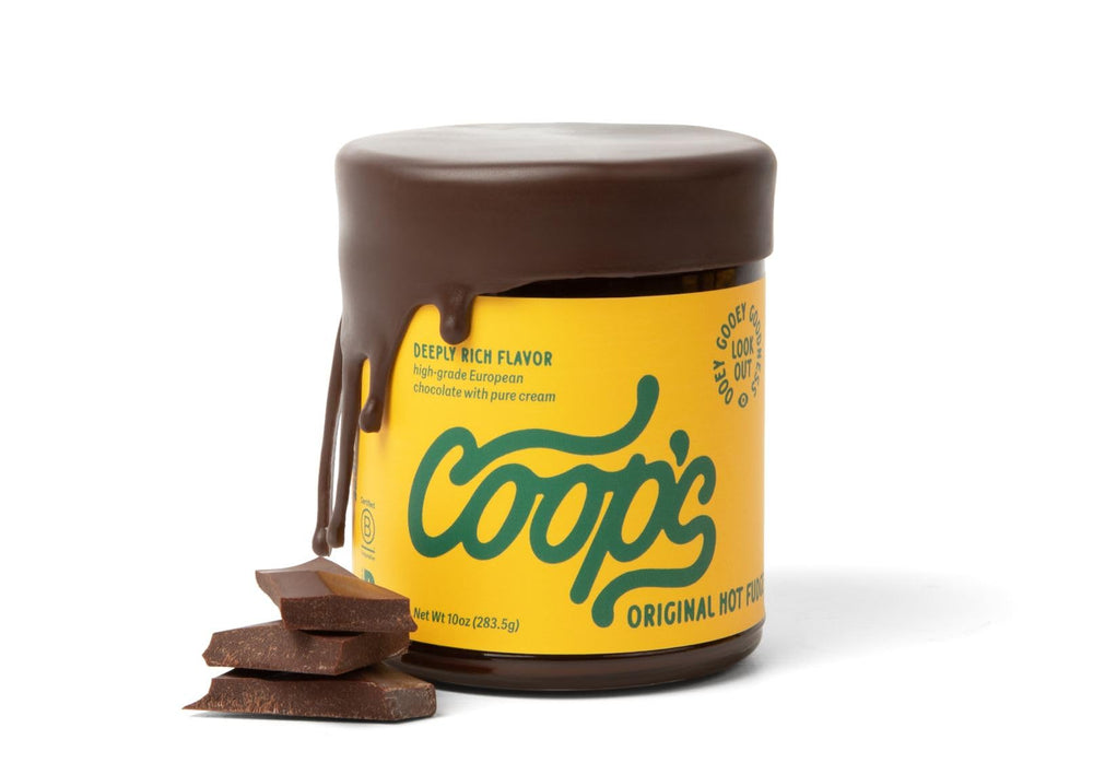 Coop's Original Hot Fudge bottle being poured, a rich topping for sundaes.