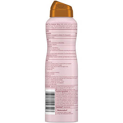 Coppertone Glow spray in hand ready for SPF on the go