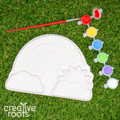 Creative Roots paintbrush and acrylic paints close-up for DIY rainbow patterns.