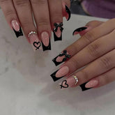 CTTHNBD coffin nails with black French tip and bow charms for a dramatic at-home manicure.