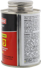 Applying DAP Weldwood cement to a wooden surface for a strong bond.