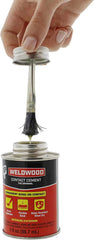 Close-up of DAP Weldwood bottle showing clear-drying formula for seamless finishes.