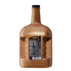 DaVinci Gourmet caramel sauce being poured into coffee to create creamy caramel notes.