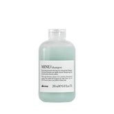 Davines MINU shampoo bottle closeup highlights color protection for treated hair.