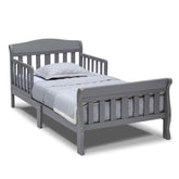 Delta Children Canton toddler bed grey front view shows sturdy wood construction for safe transition.
