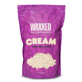 Dermwax WAXXED cream hard wax beads closeup showing creamy texture for even application
